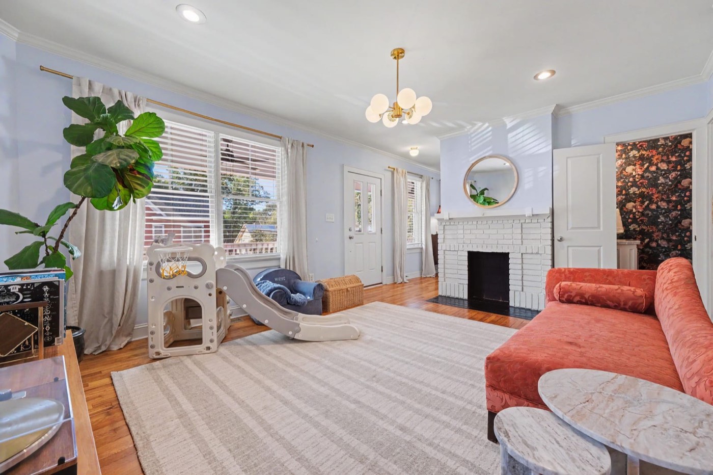 Living room with original heart pine floors and a decorative fireplace