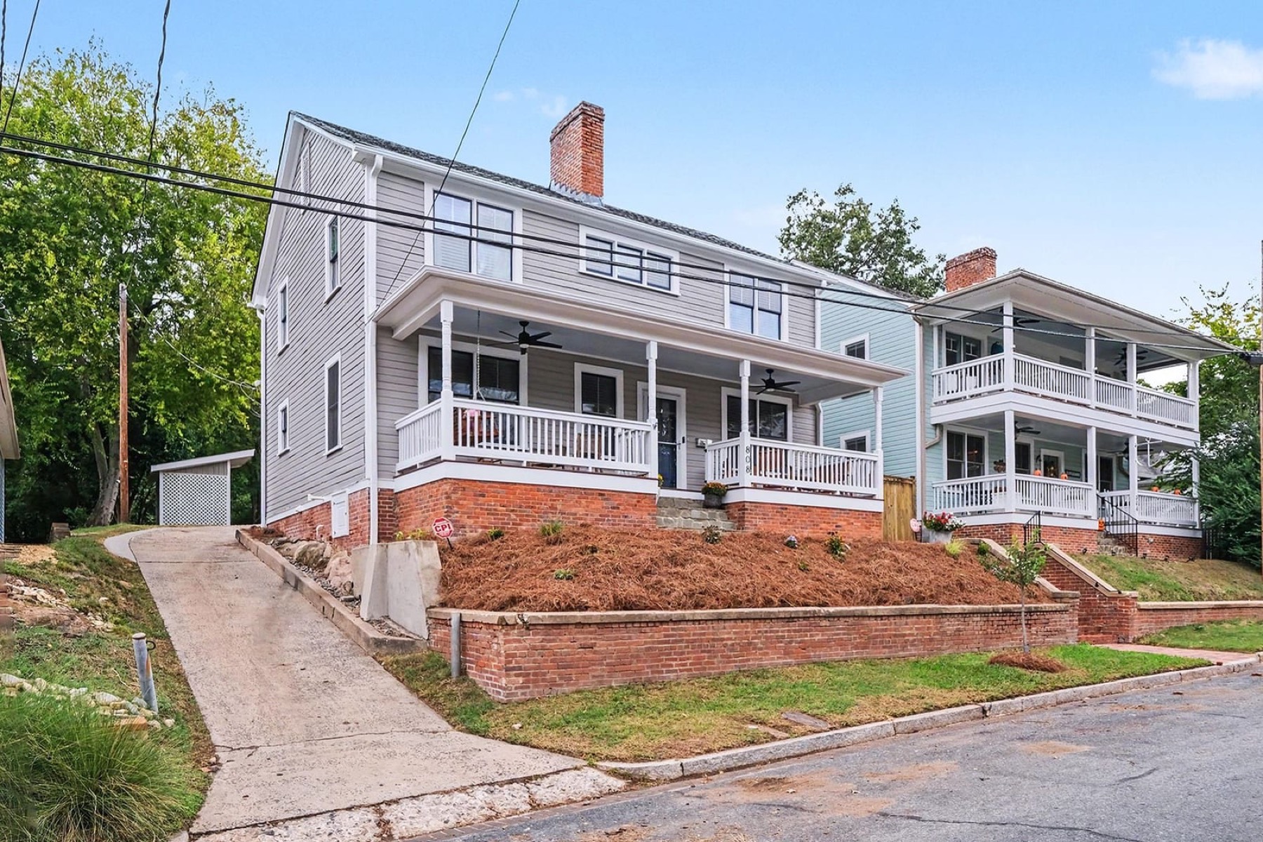 Front of 808 Yancey Street, a two-story 1937 home with a deep covered porch in Morehead Hill, Durham