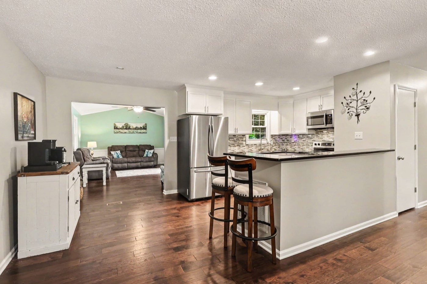 Open kitchen and living area with engineered hardwood floors